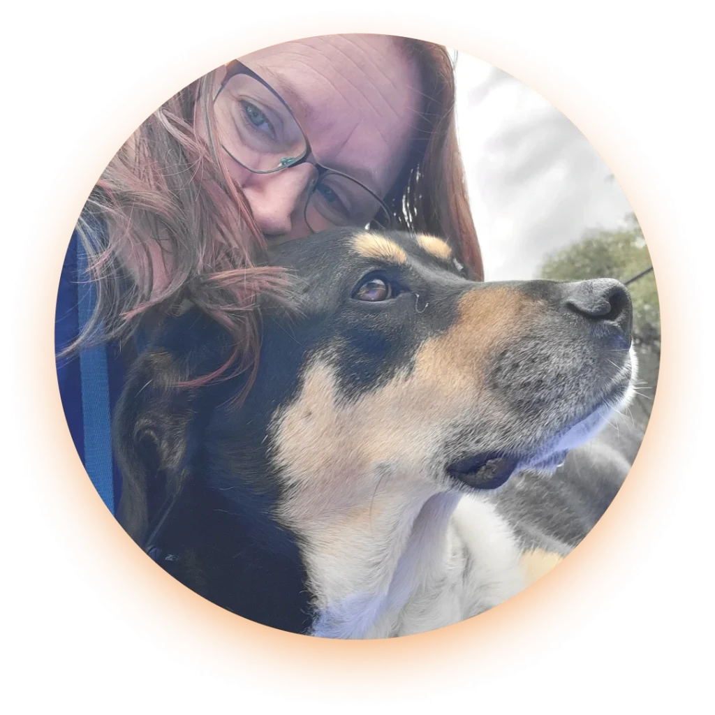 Woman in glasses taking a selfie with a dog